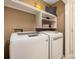 Functional laundry room with overhead shelving and modern washer and dryer units at 172 Valleybrook Dr # 8, Denver, NC 28037