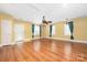 Spacious living room features wood floors, ceiling fan, and lots of natural light from the windows at 172 Valleybrook Dr # 8, Denver, NC 28037