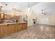 Open-concept living room boasts wood floors, stone fireplace, and an elegant chandelier at 172 Valleybrook Dr # 8, Denver, NC 28037