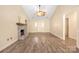 Open living room boasting wood floors, high ceilings, fireplace, and natural light at 172 Valleybrook Dr # 8, Denver, NC 28037