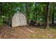 An outdoor storage shed is situated on a lot with mature trees, and a wooden fence at 172 Valleybrook Dr # 8, Denver, NC 28037