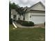 Charming home featuring a two-car garage, landscaped front yard, and light yellow vinyl siding at 19157 Mallard Dr, Fort Mill, SC 29707