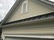 Close-up of the traditional exterior with beige siding and trim, plus a gable with vent at 19157 Mallard Dr, Fort Mill, SC 29707