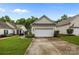 A white garage stands out beside a walkway and a beautifully manicured garden at 19157 Mallard Dr, Fort Mill, SC 29707