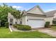 One-car attached garage featuring siding, black gutters, fresh landscaping, and a concrete drive at 19157 Mallard Dr, Fort Mill, SC 29707