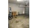 Spacious garage with cement floor, ladder, two boxes and partially open garage door at 19157 Mallard Dr, Fort Mill, SC 29707