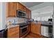 Well-equipped kitchen with wooden cabinetry, stainless steel appliances, and a view to adjacent living space at 19157 Mallard Dr, Fort Mill, SC 29707