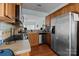 Functional kitchen showcasing stainless steel appliances, wooden cabinets, and a view into the living area at 19157 Mallard Dr, Fort Mill, SC 29707