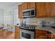 Kitchen with stainless steel appliances, dark countertops, wooden cabinets, and modern fixtures at 19157 Mallard Dr, Fort Mill, SC 29707