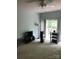 Bright living room with sliding doors to balcony, neutral carpet, and ceiling fan at 19157 Mallard Dr, Fort Mill, SC 29707