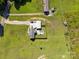 An aerial view displays the property, a swimming pool, and the surrounding grassy landscape at 2268 Westbrook Rd, Edgemoor, SC 29712