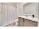 Compact bathroom with wood-look floors, single sink vanity, and shower with curtain at 2268 Westbrook Rd, Edgemoor, SC 29712