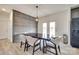 Modern dining area with rustic wood accent wall, contemporary light fixture, and seating for six at 2268 Westbrook Rd, Edgemoor, SC 29712