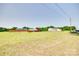 Large vacant land parcel with some neighboring homes, a wooden fence, and several utility vehicles at 2268 Westbrook Rd, Edgemoor, SC 29712