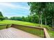 Scenic view from the wooden deck overlooking a sprawling green backyard and trees at 2728 Touchstone Cir, Newton, NC 28658