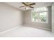 Bright bedroom with arched window offering natural light, neutral walls, and plush carpeting at 2728 Touchstone Cir, Newton, NC 28658