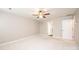 Carpeted bedroom features light walls, a ceiling fan, and an entry door at 2728 Touchstone Cir, Newton, NC 28658