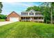 A large, two-story home features manicured landscaping and a sprawling lawn at 2728 Touchstone Cir, Newton, NC 28658