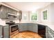 Well-lit kitchen featuring stainless steel appliances and a hardwood floor at 2728 Touchstone Cir, Newton, NC 28658
