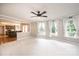 Bright living room with large windows, ceiling fan, and easy flow into kitchen at 2728 Touchstone Cir, Newton, NC 28658