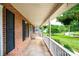 Inviting covered porch with decorative hanging plants and a view of the landscaped yard at 2728 Touchstone Cir, Newton, NC 28658