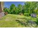 Expansive backyard with mature trees and multiple storage buildings at 286 Southside Rd, Rock Hill, SC 29730