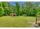 Large backyard with several storage units amidst mature trees at 286 Southside Rd, Rock Hill, SC 29730