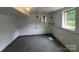 Spacious basement provides ample potential for storage or customization with painted cinderblock walls and window at 286 Southside Rd, Rock Hill, SC 29730