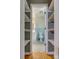 Full bathroom with blue tiling, a toilet, and a vanity, seen through the shelving at 286 Southside Rd, Rock Hill, SC 29730