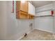 Functional laundry area with overhead shelving, storage cabinets, and hookups at 286 Southside Rd, Rock Hill, SC 29730