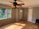 Bright living room with wood floors, ceiling fan, and natural light from the windows near the front door at 286 Southside Rd, Rock Hill, SC 29730