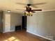 Cozy living room with wood floors, ceiling fan and light, plus a decorative fireplace, offers classic charm at 286 Southside Rd, Rock Hill, SC 29730