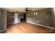 Spacious living room featuring hardwood floors, a ceiling fan, and a cozy electric fireplace at 286 Southside Rd, Rock Hill, SC 29730
