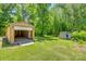 Wooden outbuilding with open garage door on a lush green lawn surrounded by tall trees at 286 Southside Rd, Rock Hill, SC 29730