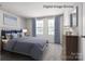 Bedroom featuring a soft bed, carpeted floor, side tables, lamps and curtains at 3232 Dannelly Towns Aly # 1006C, Charlotte, NC 28208