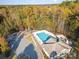 Aerial view of the community pool surrounded by trees and a playground offering a great recreational space at 35 Dorie Dr, Belmont, NC 28012