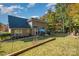 Expansive backyard with lush lawn, mature trees, and a patio perfect for outdoor entertaining at 35 Dorie Dr, Belmont, NC 28012
