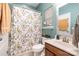 Bright bathroom with a shower-tub combo, floral shower curtain, and wood vanity at 35 Dorie Dr, Belmont, NC 28012