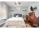 Cozy bedroom with a queen bed, decorative shelves, and a modern ceiling fan at 35 Dorie Dr, Belmont, NC 28012