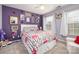 Bedroom features a large bed with floral bedding, two windows, and fun wall decor at 35 Dorie Dr, Belmont, NC 28012