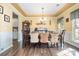 Elegant dining room featuring a tray ceiling, hardwood floors, and a stylish chandelier to set the mood at 35 Dorie Dr, Belmont, NC 28012