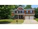 Charming two-story brick home featuring a well-manicured lawn and an attached two-car garage at 35 Dorie Dr, Belmont, NC 28012