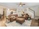 The expansive living room is open to the kitchen and features hardwood floors and neutral paint colors at 35 Dorie Dr, Belmont, NC 28012