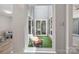 A view from inside the home of the outdoor lounge area with comfortable furniture and privacy at 3807 Sweetgrass Ln, Charlotte, NC 28226