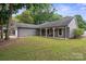 Spacious ranch-style home with well-manicured lawn, covered porch, and attached garage at 3807 Sweetgrass Ln, Charlotte, NC 28226