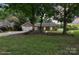 Charming single-story home with a well-manicured lawn, mature trees, and a cozy covered porch at 3807 Sweetgrass Ln, Charlotte, NC 28226