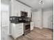 Kitchen featuring stainless steel appliances, white cabinetry and decorative backsplash at 3807 Sweetgrass Ln, Charlotte, NC 28226