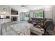 Open-concept living room with vaulted ceilings, stone fireplace, and cozy seating area at 3807 Sweetgrass Ln, Charlotte, NC 28226