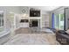 Inviting living room showcasing a stone fireplace, built-in shelving, and bright ambiance at 3807 Sweetgrass Ln, Charlotte, NC 28226