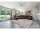 Comfortable living room with expansive sectional sofa, natural light, and a large ceiling fan at 3807 Sweetgrass Ln, Charlotte, NC 28226